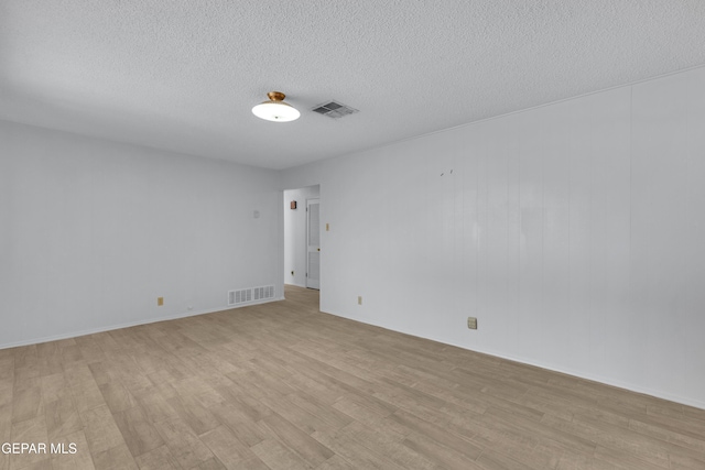 10125 Castletown Dr, El Paso, TX 79925 - empty room featuring light wood finished floors, a textured ceiling, and baseboards