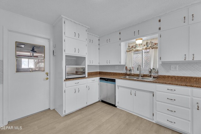 10125 Castletown Dr, El Paso, TX 79925 - kitchen featuring stainless steel dishwasher, a sink, light wood-style floors, white cabinets, and a textured ceiling
