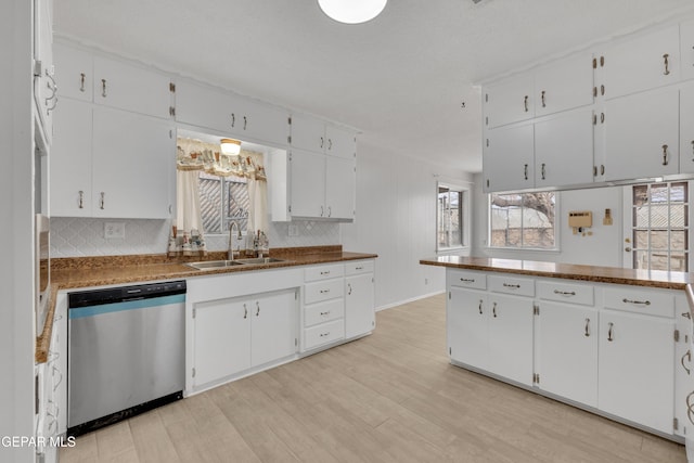 10125 Castletown Dr, El Paso, TX 79925 - kitchen featuring stainless steel dishwasher, a sink, white cabinets, and light wood finished floors