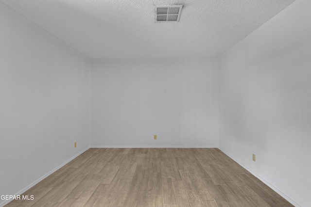 10125 Castletown Dr, El Paso, TX 79925 - spare room with wood finished floors, a textured ceiling, and baseboards