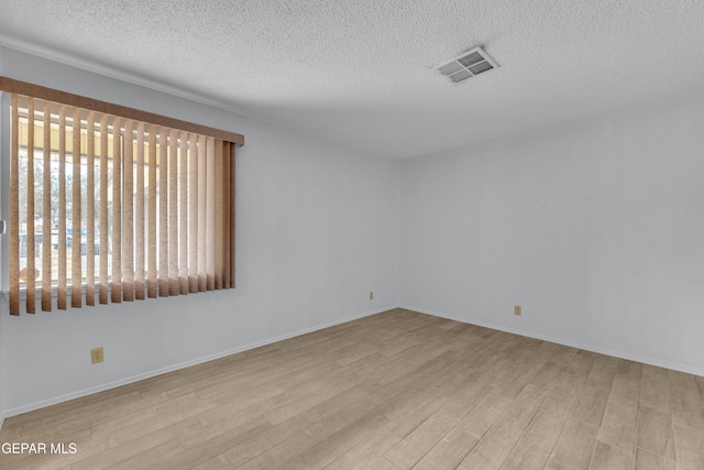 10125 Castletown Dr, El Paso, TX 79925 - spare room with wood finished floors, a textured ceiling, and baseboards