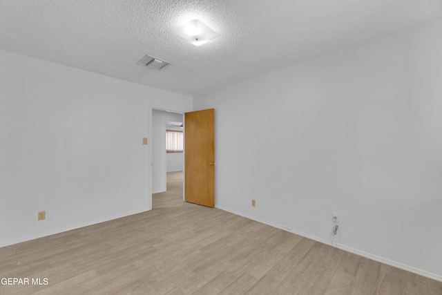 10125 Castletown Dr, El Paso, TX 79925 - spare room with light wood-type flooring, a textured ceiling, and baseboards