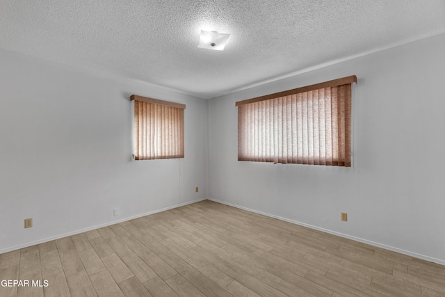 10125 Castletown Dr, El Paso, TX 79925 - empty room with a textured ceiling, wood finished floors, and baseboards