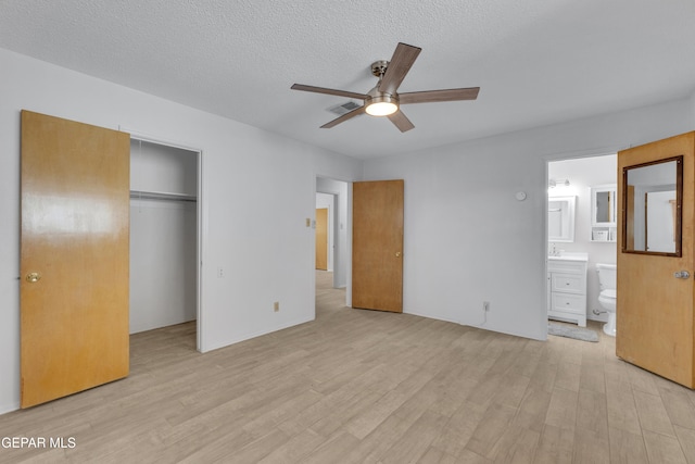 10125 Castletown Dr, El Paso, TX 79925 - unfurnished bedroom featuring light wood finished floors, a closet, ensuite bathroom, a textured ceiling, and ceiling fan