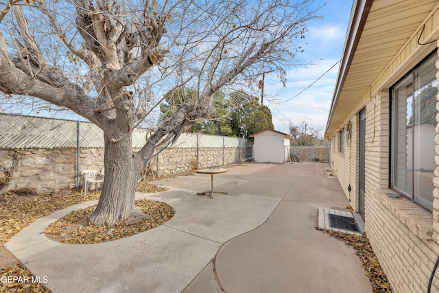 10125 Castletown Dr, El Paso, TX 79925 - view of patio with a shed, a fenced backyard, and an outdoor structure