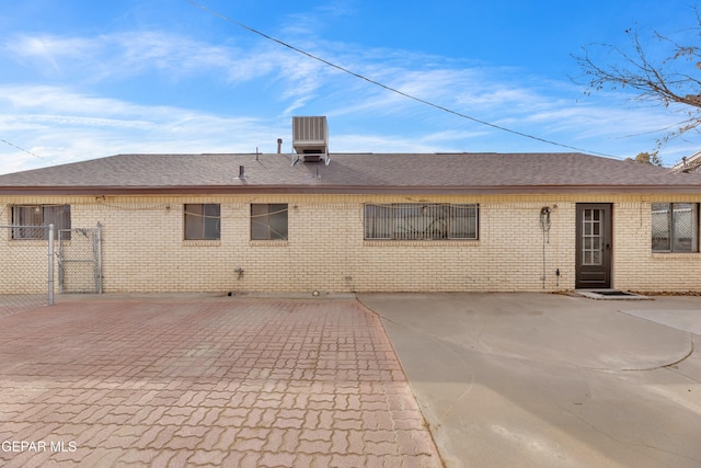 10125 Castletown Dr, El Paso, TX 79925 - rear view of house with brick siding, fence, and roof with shingles