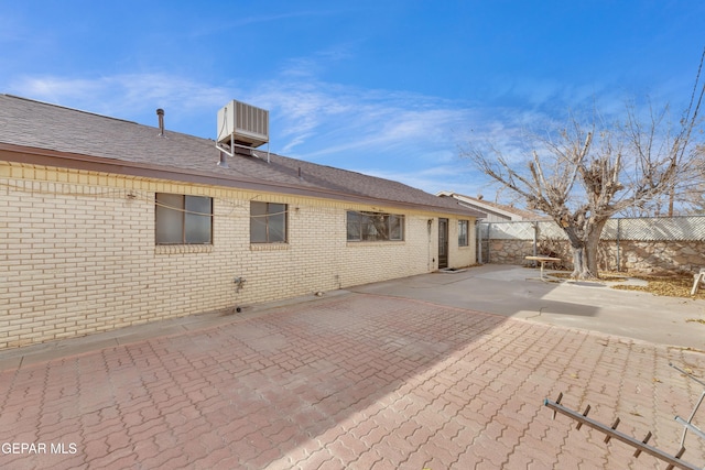 10125 Castletown Dr, El Paso, TX 79925 - back of property with fence, brick siding, and a patio area