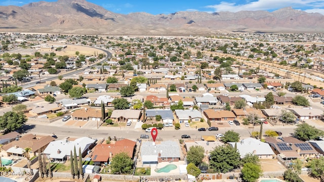 view of property location featuring a mountain backdrop and nearby suburban area