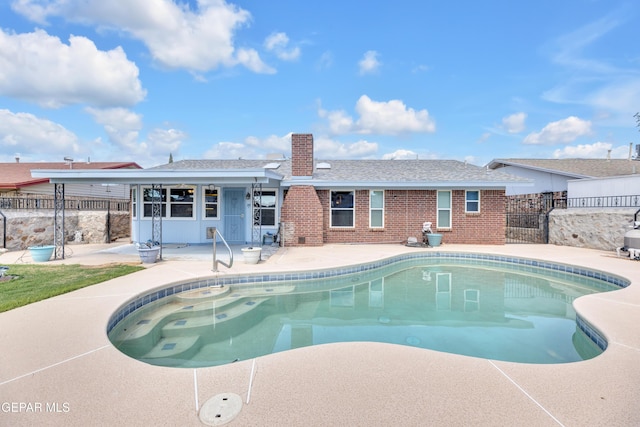 view of pool with a patio and fence