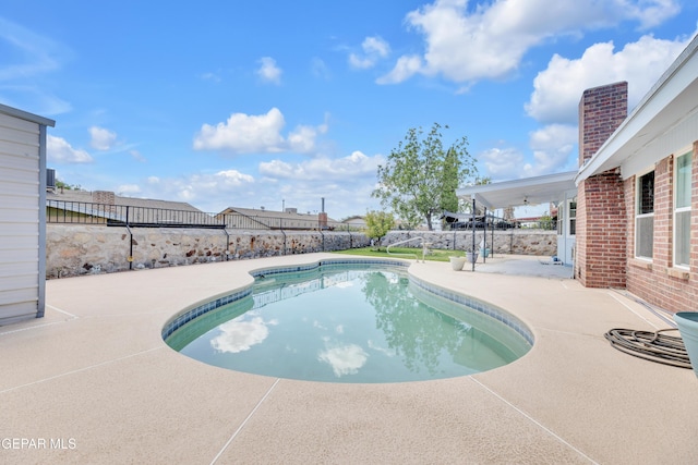 view of swimming pool featuring a patio and a fenced backyard