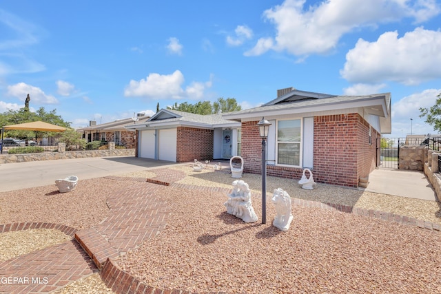 ranch-style house featuring brick siding, driveway, an attached garage, and fence