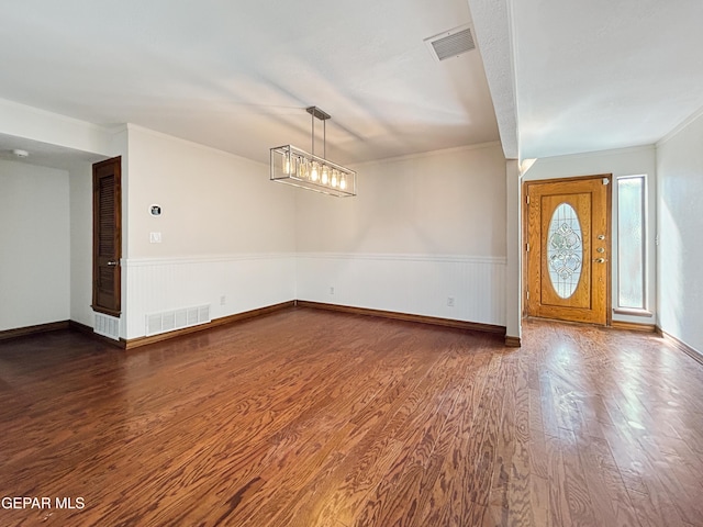 852 Cresta Alta Dr, El Paso, TX 79912 - entrance foyer featuring wood finished floors, a wainscoted wall, crown molding, and baseboards