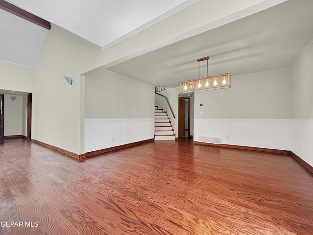 852 Cresta Alta Dr, El Paso, TX 79912 - unfurnished living room featuring wood finished floors, wainscoting, stairway, and ornamental molding