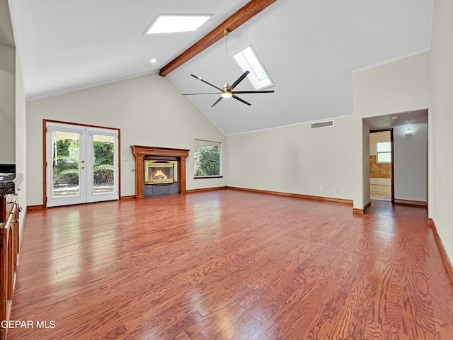 852 Cresta Alta Dr, El Paso, TX 79912 - unfurnished living room featuring beamed ceiling, a skylight, ceiling fan, high vaulted ceiling, and wood finished floors