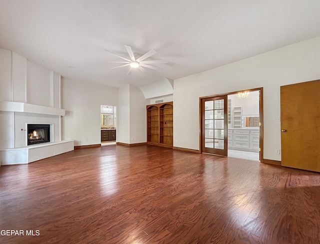 852 Cresta Alta Dr, El Paso, TX 79912 - unfurnished living room featuring a ceiling fan, a large fireplace, wood finished floors, and baseboards