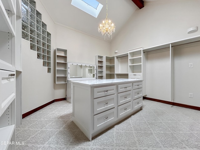 852 Cresta Alta Dr, El Paso, TX 79912 - walk in closet featuring a skylight, a chandelier, high vaulted ceiling, light carpet, and beamed ceiling