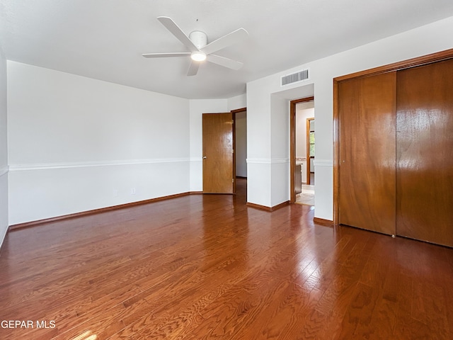 852 Cresta Alta Dr, El Paso, TX 79912 - unfurnished bedroom featuring wood finished floors, baseboards, a ceiling fan, and a closet