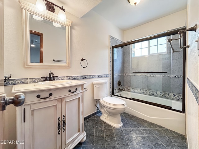 852 Cresta Alta Dr, El Paso, TX 79912 - bathroom featuring toilet, bath / shower combo with glass door, and vanity