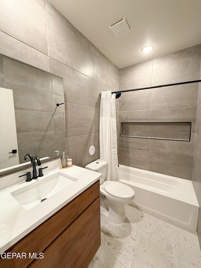 15101 Steer Dr, El Paso, TX 79938 - bathroom featuring shower / tub combo with curtain, vanity, tile walls, and toilet