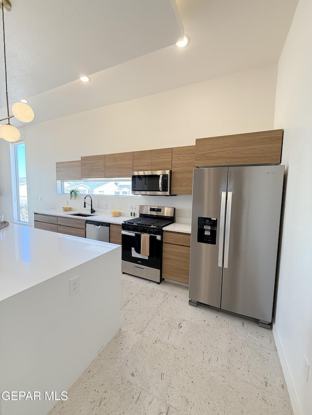 15101 Steer Dr, El Paso, TX 79938 - kitchen featuring stainless steel appliances, light countertops, brown cabinetry, a sink, and recessed lighting