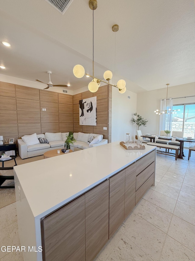 15101 Steer Dr, El Paso, TX 79938 - kitchen with light countertops, a center island, hanging light fixtures, a ceiling fan, and recessed lighting
