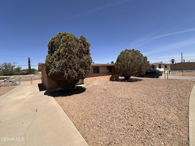 view of front of property with fence and brick siding
