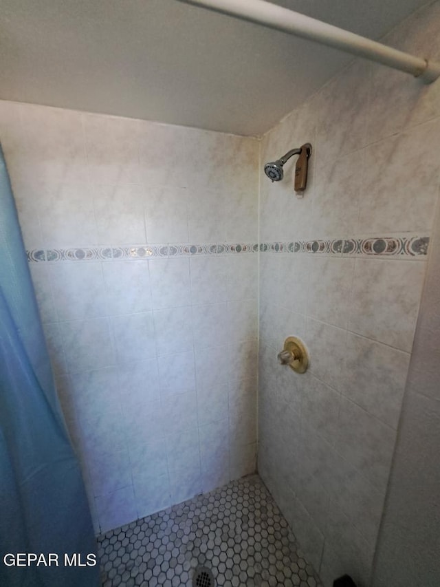 bathroom with tiled shower