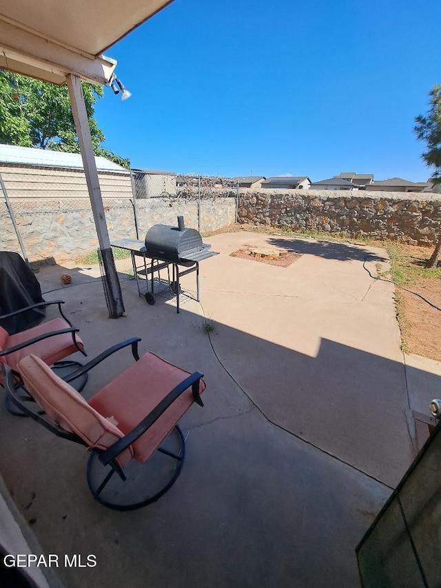 view of patio / terrace featuring a fenced backyard and a grill