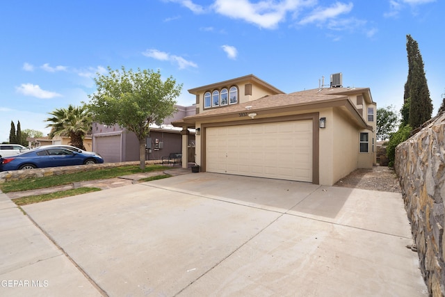 traditional home with stucco siding, driveway, central air condition unit, and an attached garage