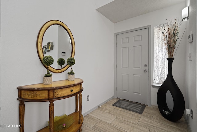 entrance foyer featuring wood finish floors and baseboards