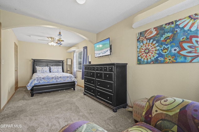 bedroom featuring arched walkways and carpet flooring