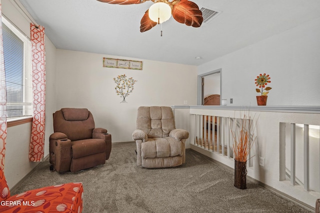 sitting room with carpet, ceiling fan, and baseboards