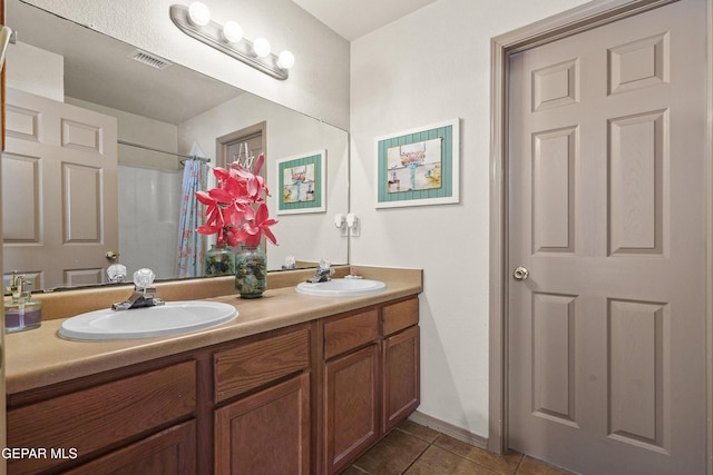 bathroom with tile patterned floors, double vanity, and a shower with curtain