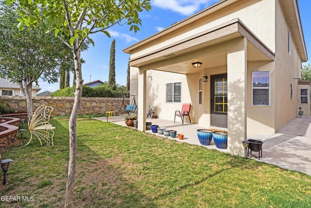 rear view of property with stucco siding and a patio area
