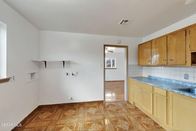 kitchen featuring open shelves, tasteful backsplash, light countertops, and baseboards