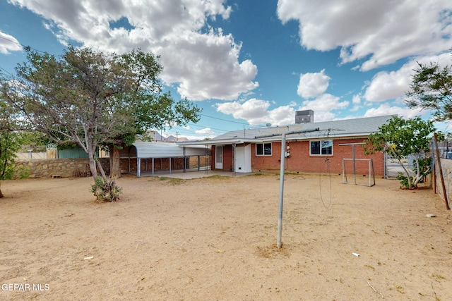 rear view of house featuring a fenced backyard and brick siding