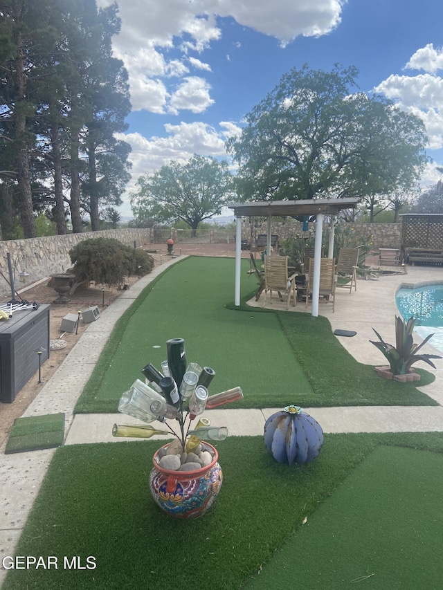 view of property's community with a putting area, fence, and a pool