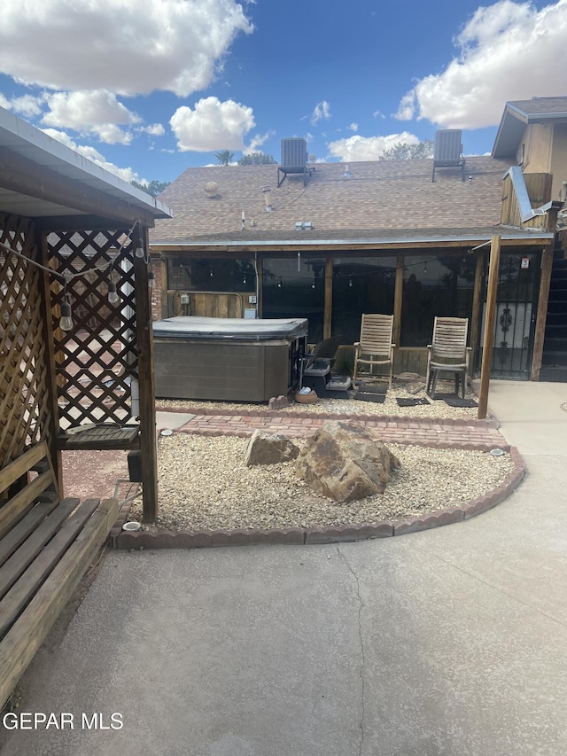 view of patio featuring a hot tub and cooling unit