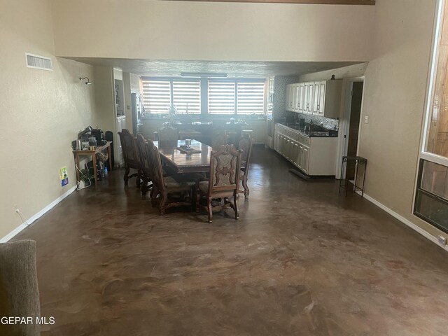 dining area with concrete floors and baseboards