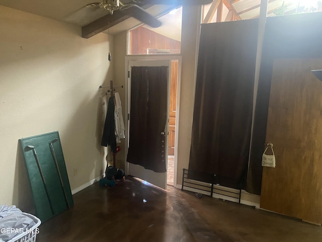 entrance foyer with ceiling fan and baseboards