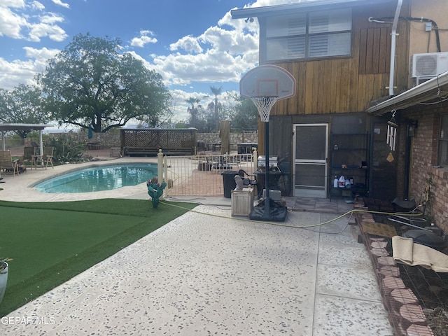 view of swimming pool with a patio area and fence