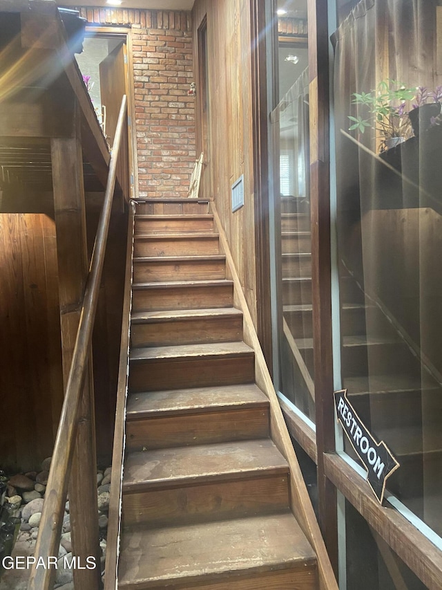 stairs with brick wall and wooden walls