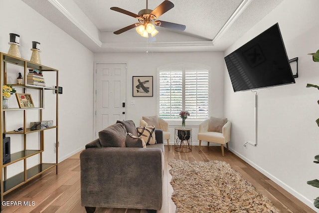 4729 Joseph Rodriguez Dr, El Paso, TX 79938 - living room with ceiling fan, lofted ceiling, wood finished floors, a raised ceiling, and baseboards