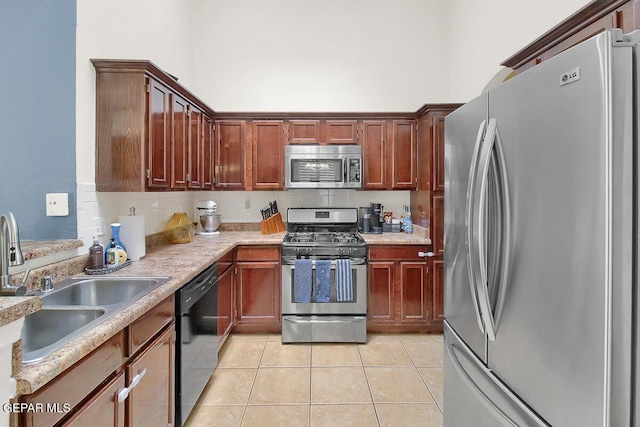 4729 Joseph Rodriguez Dr, El Paso, TX 79938 - kitchen featuring appliances with stainless steel finishes, a sink, light tile patterned floors, light countertops, and backsplash