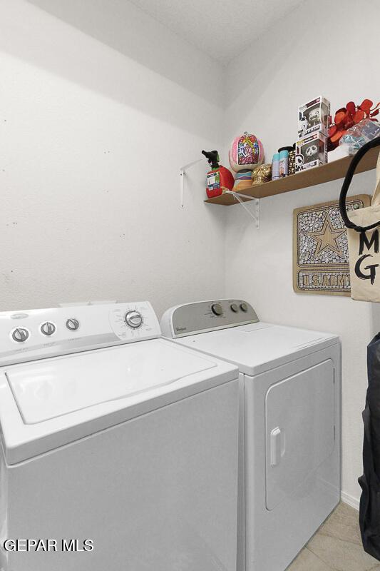 4729 Joseph Rodriguez Dr, El Paso, TX 79938 - laundry area with separate washer and dryer and light tile patterned floors