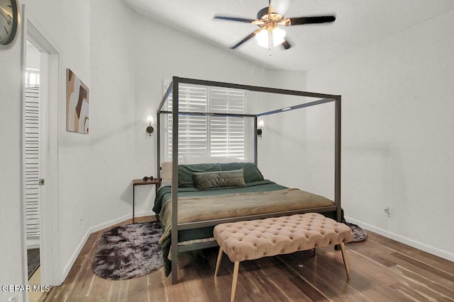4729 Joseph Rodriguez Dr, El Paso, TX 79938 - bedroom with baseboards, wood finished floors, a ceiling fan, vaulted ceiling, and multiple windows