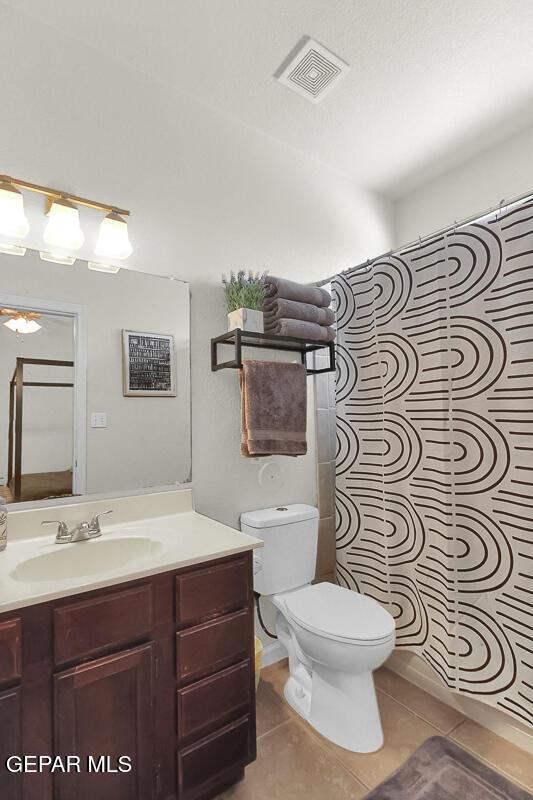 4729 Joseph Rodriguez Dr, El Paso, TX 79938 - bathroom with tile patterned flooring, toilet, vanity, and a shower with shower curtain