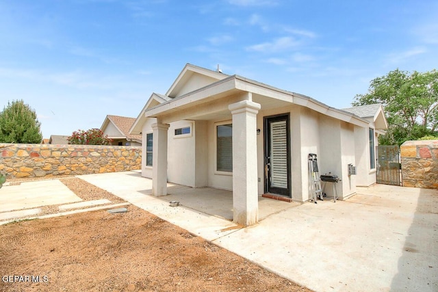 4729 Joseph Rodriguez Dr, El Paso, TX 79938 - back of house with a patio, stucco siding, fence, and a gate
