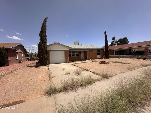 ranch-style home with an attached garage, driveway, and brick siding