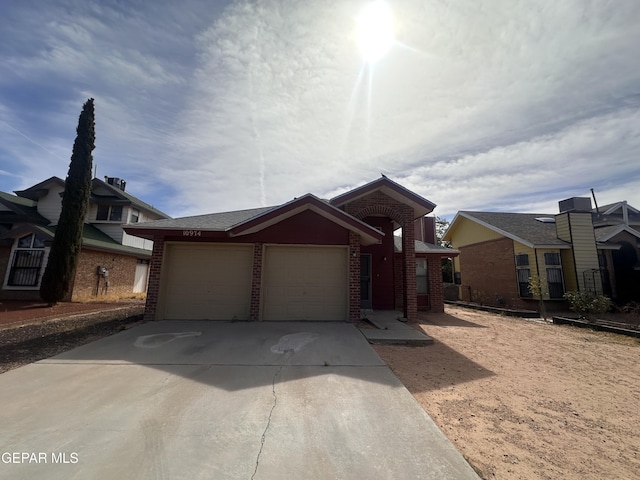 view of front of home with brick siding, an attached garage, and concrete driveway